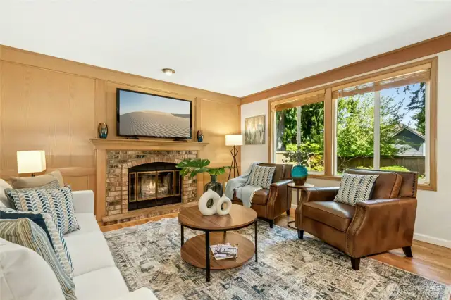 Inviting family room with a fireplace and a wall of widows allowing for lots of natural light.