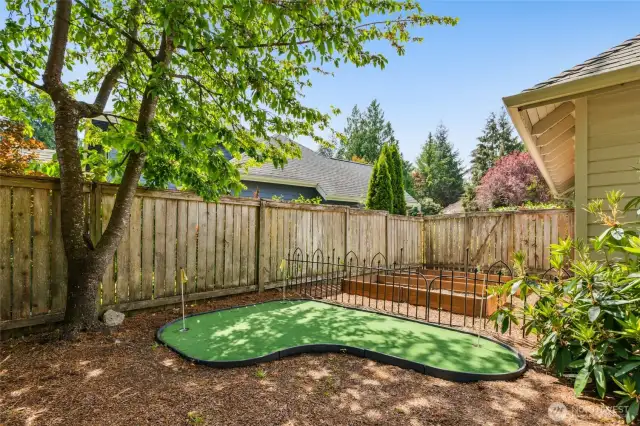 Golf putting area and raised garden beds for vegetables, herbs and flowers.