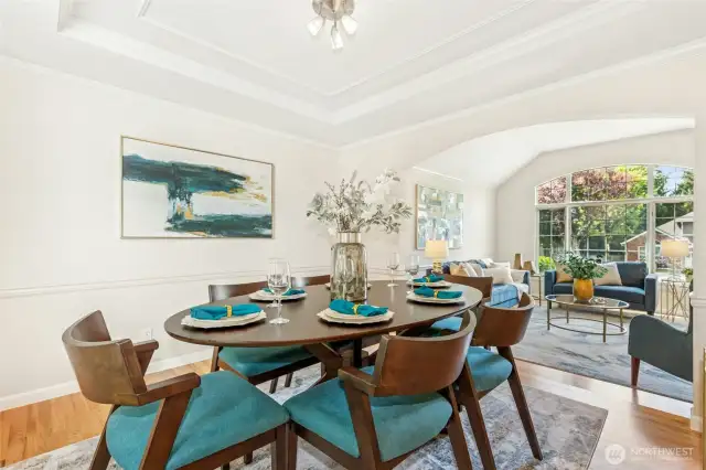 Formal dining room with a gorgeous tray ceiling and more fine, chair rail finish work.