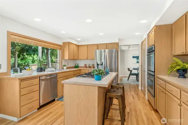 Delightful kitchen with sleek stainless steel appliances, abundant cabinetry and casual eating nook.