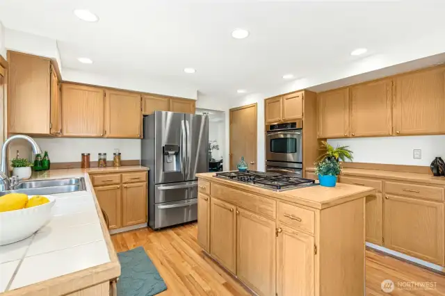 Angle including the pantry and ample cabinetry and counter space.