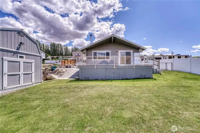 The fully fenced yard adds privacy and space for pets, gardening, or entertaining.