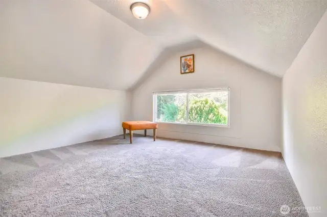 Cozy upstairs bedroom with bright windows and peaceful vibes
