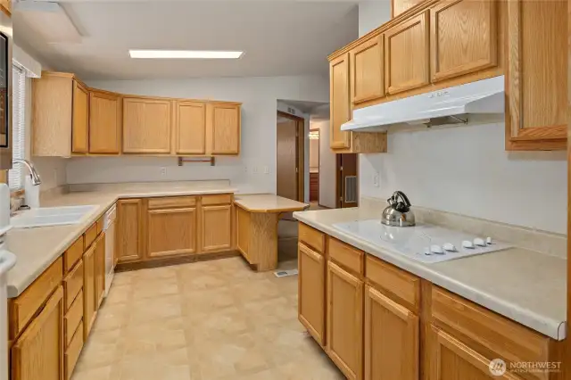 Kitchen not only has a breakfast nook but an eating bar.