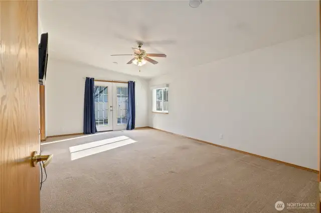 Primary bedroom with french doors to back patio.