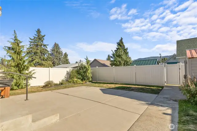 Easy maintenance back yard with large patio and underground sprinkler system.  Tall privacy vinyl fence with gate to the alley.