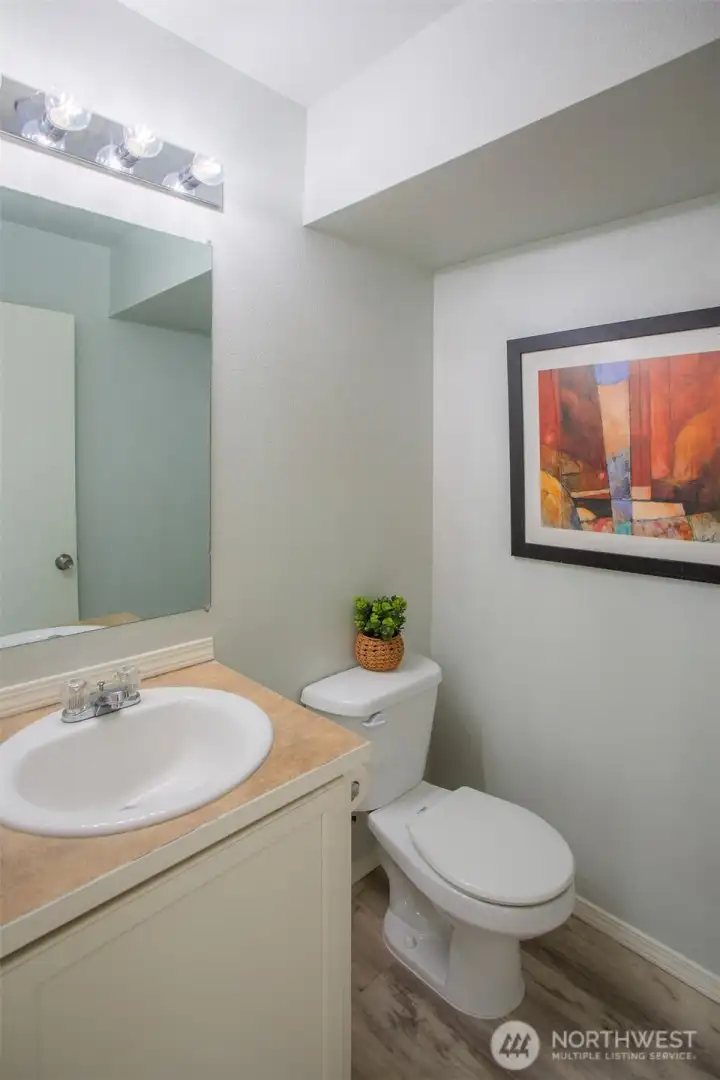 Powder Room on the Main Floor with New Waterproof Vinyl Flooring.