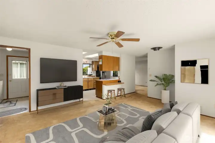 Virtually staged Great room/living room looking towards kitchen and eating bar.