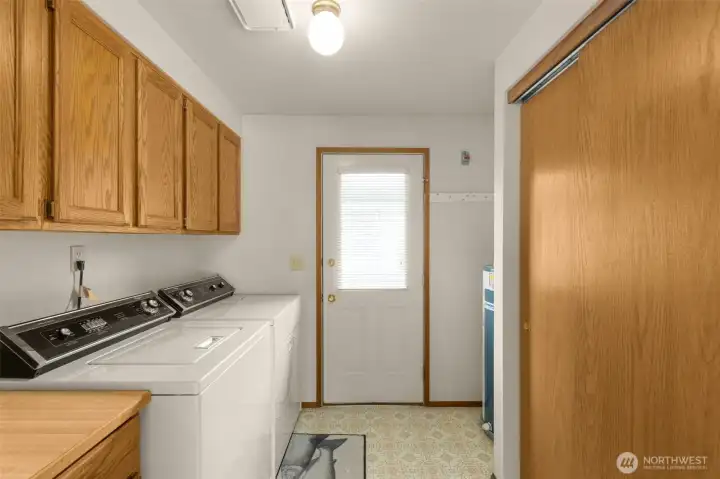 Laundry with door to side of home with ramp and new stairs