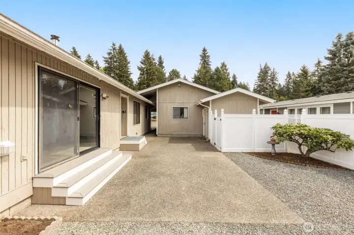 Private Patio with new fence and area to hide garbage cans or BBQ. Easy maintenance gardens