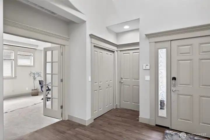 Just off the entry and through the beautiful French doors is the thoughtfully designed office with architectural details.