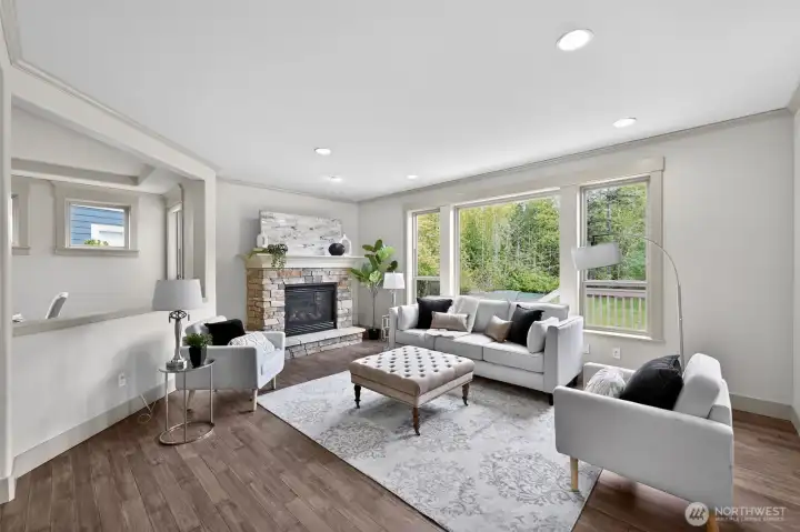 Family room impresses with a stone gas fireplace & huge window. Great for cold days and long winter nights! Adds an additional touch of warmth!