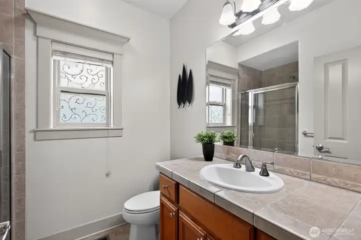 Conveniently located beautiful main-floor bath with a shower and beautiful tiling!