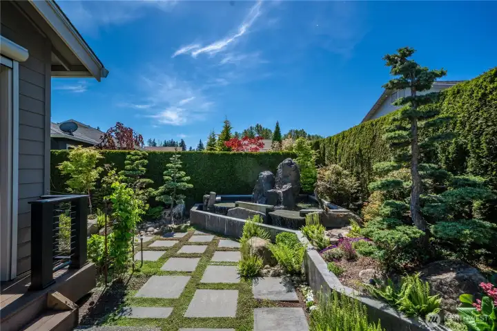 This low maintenance and dreamy backyard with extensive hardscape, mature plantings and a stunning water feature. 172 Arborvitae create an impressive privacy hedge on this West facing sun drenched lot.