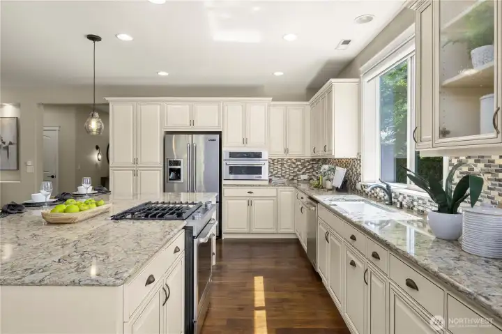 This kitchen is extraordinary! Gorgeous Quart counters, full height custom backsplash, stunning cabinetry with pull outs, single undermount sink and high-end JennAir appliance package.