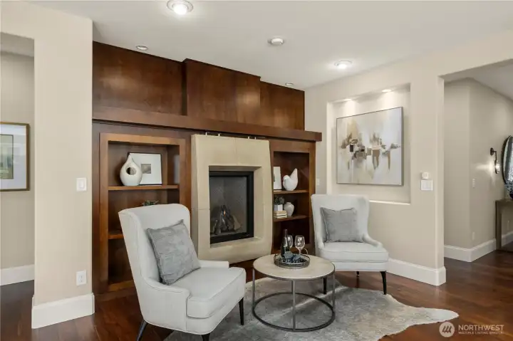 Stunning custom concrete gas fireplace with built-ins and art niche create a cozy spot to gather, read or play a game!
