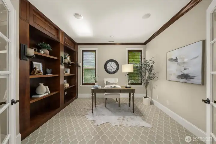 French doors open to the spacious den with beautiful built-ins, crown molding, surround sound and high-end carpet.