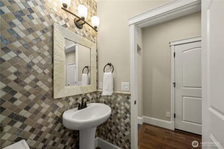 The statement powder room with the designer feature wall will impress your guests!