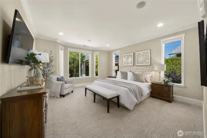 The peaceful primary bedroom offers a charming bay window, crown molding, surround sound and high-grade carpet and pad. Bask in the privacy and scenic views from your bedroom!