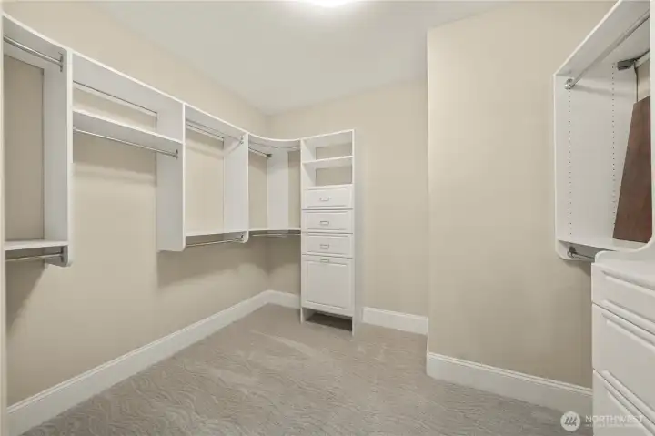 Huge walk-in closet with custom shelving.