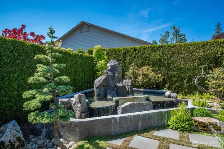 This amazing water feature is the focal point of this majestic backyard sanctuary.  You will love listening to this whether in the yard or the home! Custom built pump house with concrete slab, stamped & colored concrete walls for the pond, waterproofing spray liner, hand selected drilled column and decorative rocks. Wait until you experience this in the evenings!