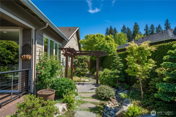 The custom arbor creates another possible seating area. So much room to spread out and enjoy this magnificent yard!