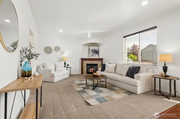 Warm and inviting family room with cozy gas fireplace, abundant natural light, and elegant neutral finishes