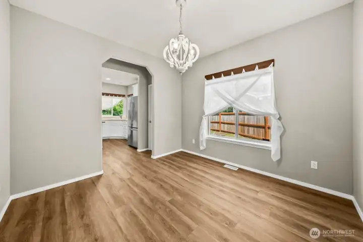 FORMAL DINING ROOM SITS PERFECTLY BETWEEN LIVING ROOM AND KITCHEN