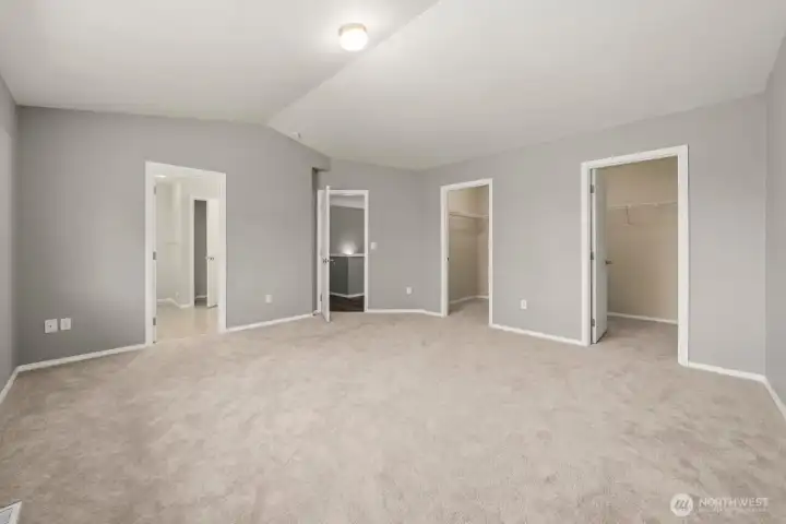 PRIMARY BEDROOM WITH ENSUITE BATH, VAULTED CEILINGS AND 2 WALK IN CLOSETS