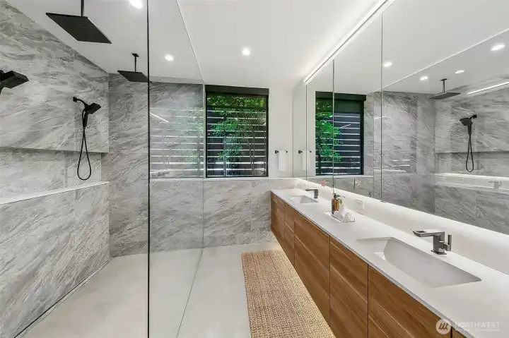 The primary bathroom with a green wall invites the outdoors in.