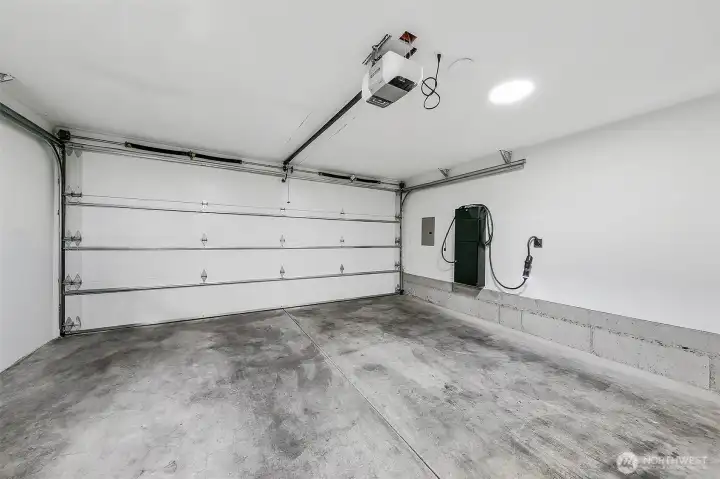 Two car garage includes e-car charging station.