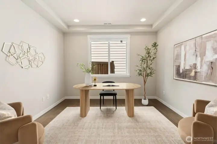 Custom barn doors reveal a flexible main-level space for work, creativity, fitness, or play.