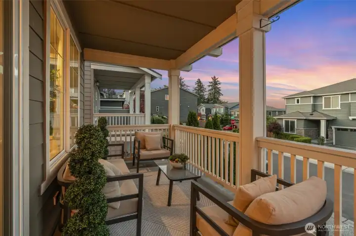 An east-facing covered balcony invites sunrise coffee or sunset drinks, fresh air, and year-round enjoyment.