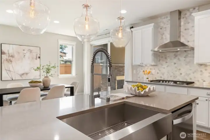 A generous quartz island anchors the space with seating, prep room, and an easy place to gather.