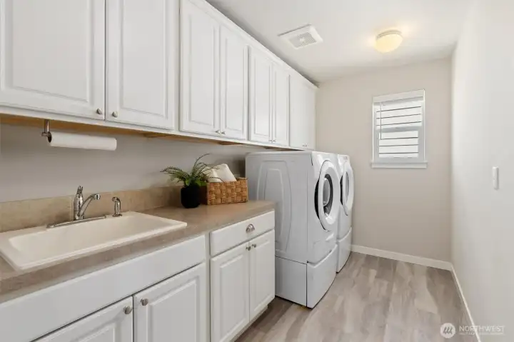 A dedicated laundry room with a utility sink and ample storage bring order and efficiency to each day.