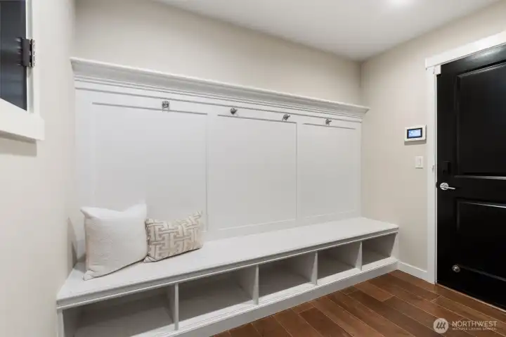 A wall-to-wall hall tree, cubby storage, and coat closet create a thoughtful drop zone for the rhythms of daily life.