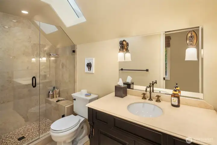 Bonus room bathroom with skylight and heated floors.