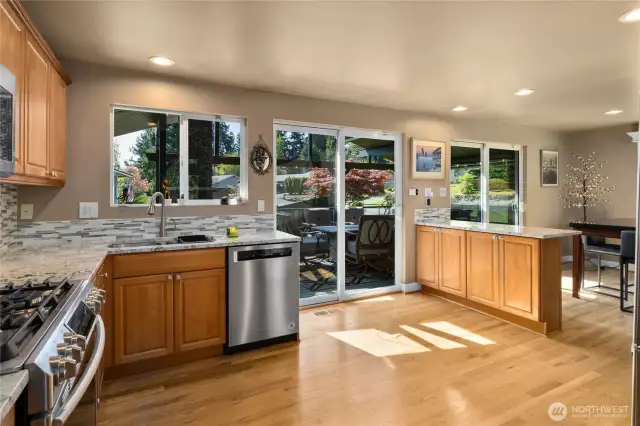 View from the Kitchen looking out to the dining room and outside through your two sliders!