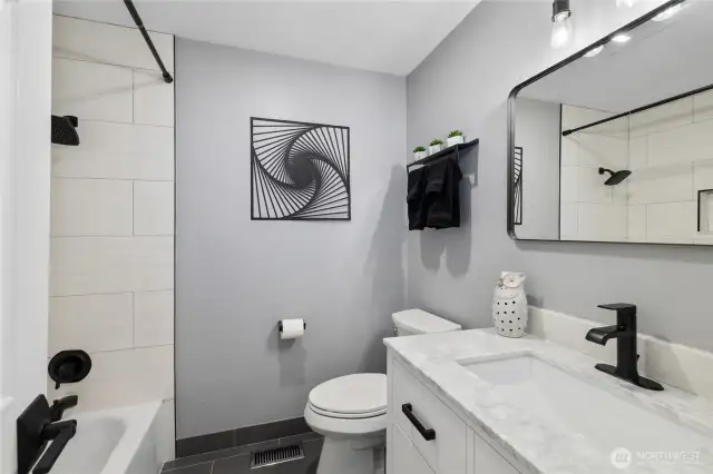 Guest full bathroom, ALL NEW completely updated tile floors, quartz vanity, new lighting, paint, Tile surround tub/shower and plumbing fixtures! BRAND NEW!