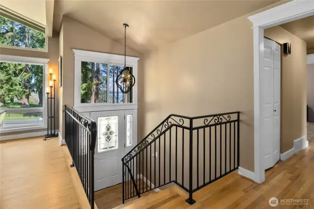Front Entry and stairwell with iron railings and REAL hardwood floors, plus the Lake View!