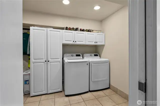 1st floor Extra Large Laundry room with tons of storage, right off the garage at the bottom of the stairs.