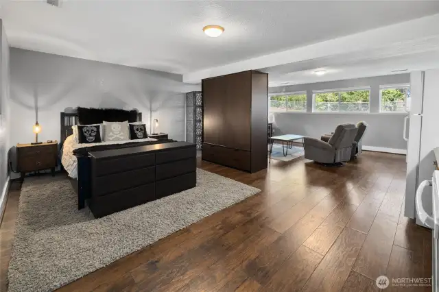 Downstairs living area, studio set up with extra large built-in armoire closet also helps define the spaces.