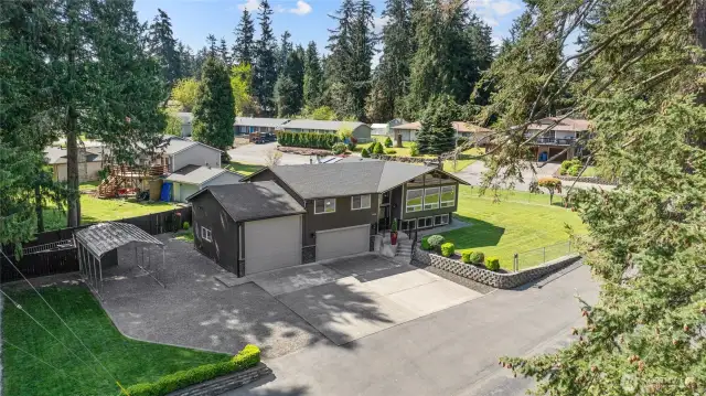 Overhead view of your home and property, large lot with only ONE Neighbor! Look at all the BEAUTIFUL landscaping and fully fenced too!