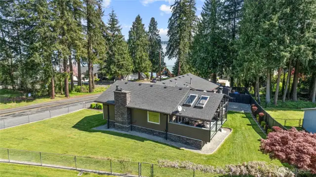 Lots of beautiful mature landscaping, look at the stacked stone accents wrap towards the back of the home and the chimney. Almost a 1/4 acre here!