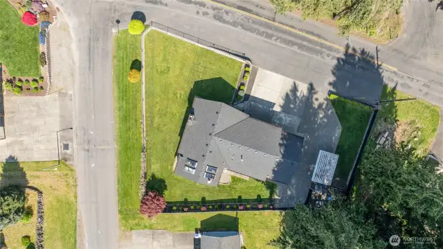 Only one neighboring property! Large shy 1/4 acre corner lot, fully fenced and look at all your parking areas!!!! Paved area out front is part of this property!