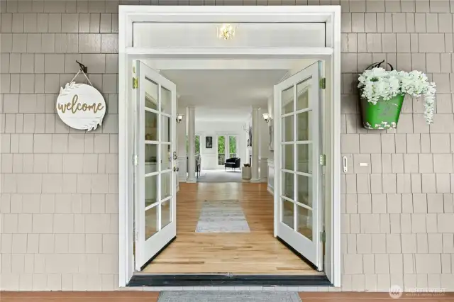 Welcoming foyer has newly refinished hardwood floors and high ceilings.