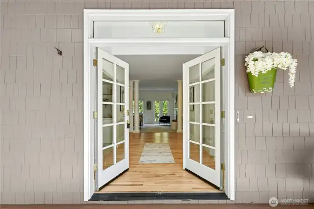 Welcoming foyer has newly refinished hardwood floors and high ceilings.