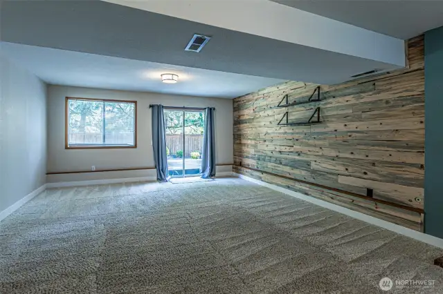 The bonus room showing a slider that accesses the backyard.