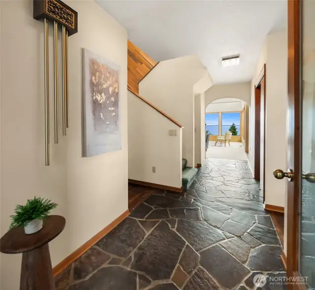 Enter from the atrium to the left to be drawn into the light-filled living room. Slate floors add so much character.