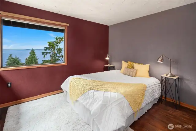 One of the two bedrooms on the main level. This one looks north to the views and west to the landscape. Real hardwood floors.